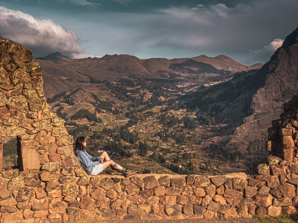Woman relaxing with a view from Pisac ruins, Peru